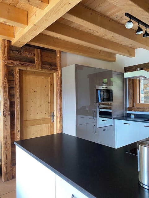 The well equipped kitchen is modern with high quality appliances.