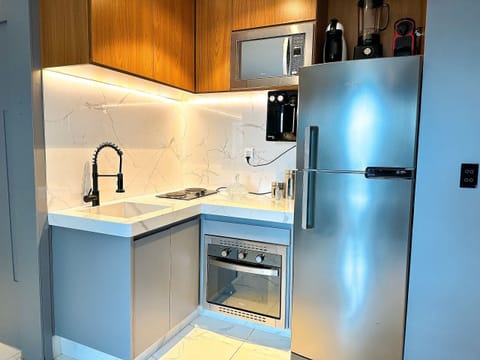 Deluxe Apartment | Private kitchen | Mini-fridge, highchair, cookware/dishes/utensils