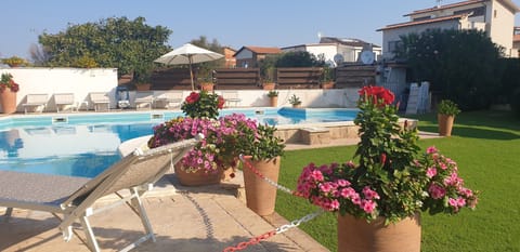 Seasonal outdoor pool, open 9:00 AM to 8:00 PM, pool umbrellas