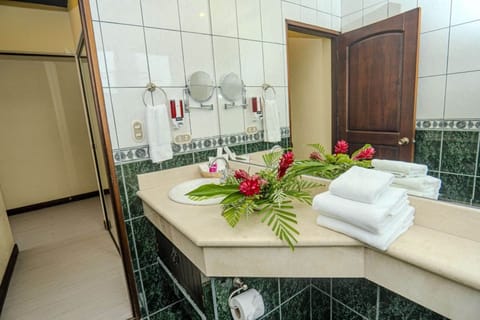 Deluxe Room, 2 Queen Beds, Non Smoking, Refrigerator & Microwave | Bathroom | Shower, hair dryer, towels