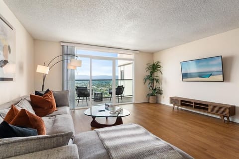 Floor-to-ceiling glass doors flood the space with brilliant, natural light.