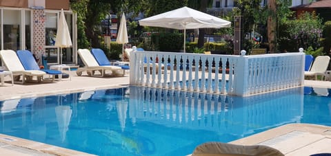 Seasonal outdoor pool, open 9:00 AM to 8:00 PM, pool umbrellas