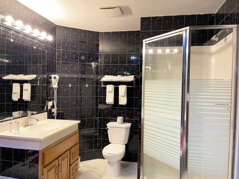 Suite, 1 King Bed, Non Smoking | Bathroom | Combined shower/tub, deep soaking tub, hair dryer, towels