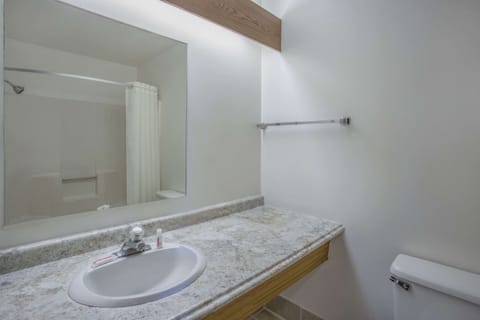Suite, 1 King Bed | Bathroom | Combined shower/tub, hair dryer, towels
