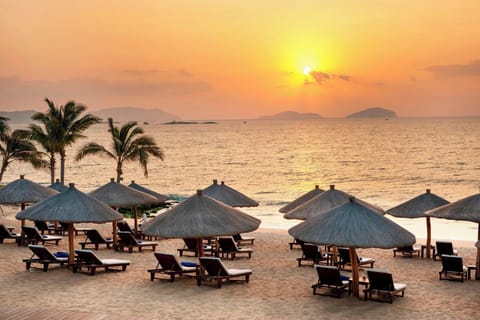 On the beach, white sand, beach umbrellas, beach towels