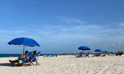 On the beach, white sand, beach umbrellas, beach towels