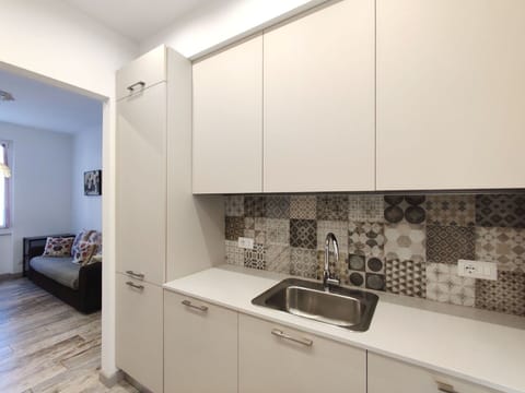 Cabinetry, Sink, Kitchen Sink, Countertop, Wood, Flooring, Interior Design, Kitchen Stove, Floor, Kitchen