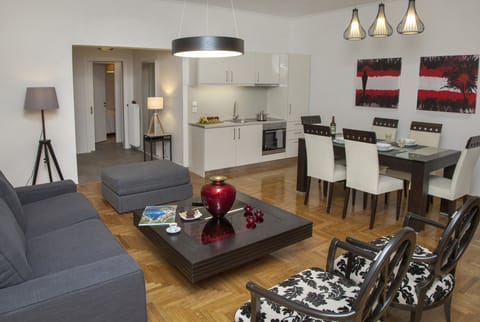 The living room with the open plan kitchen and the dining table
