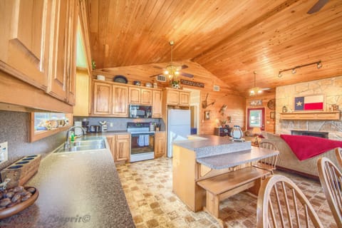 There is a bench and 3 additional bar stools at the kitchen island/ breakfast bar.