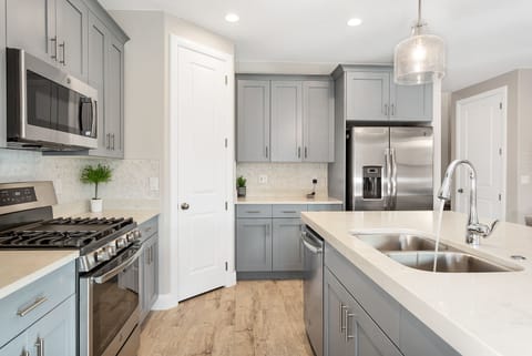 Fully stocked gourmet kitchen featuring stainless steel appliances