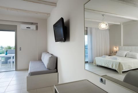 Triple Room, Partial Sea View | Minibar, in-room safe, desk, soundproofing