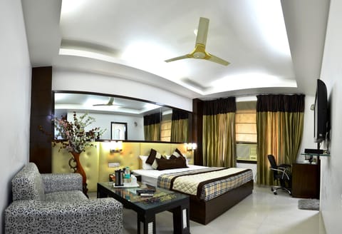 Deluxe Room | Living area | LCD TV, first-run movies