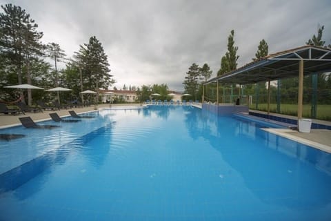 Seasonal outdoor pool, open 9:00 AM to 10:00 PM, pool umbrellas