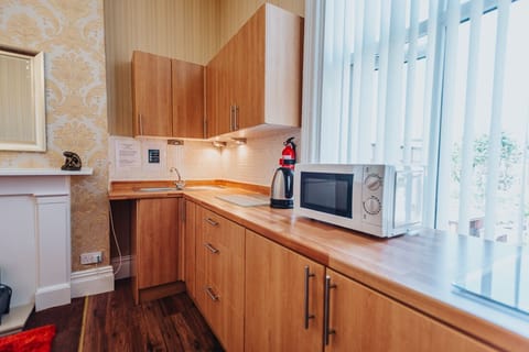 Modern kitchen offering hob & oven fridge, microwave, kettle & toaster