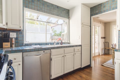 Enter into the sunny kitchen from the dining room.