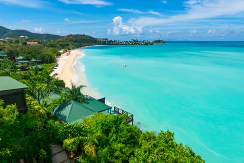 On the beach, white sand, sun loungers, beach umbrellas