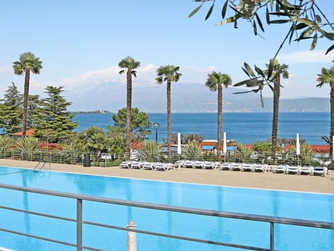 Water, Sky, Plant, Azure, Tree, Shade, Swimming Pool, Arecales, Seaside Resort, Coastal And Oceanic Landforms