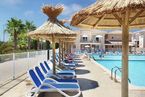 Relax in the sun beside the outdoor pool.