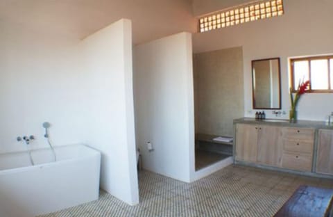 Suite, 1 King Bed, Balcony | Bathroom | Separate tub and shower, rainfall showerhead, designer toiletries
