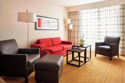 Suite, 1 King Bed with Sofa bed | Living room | 32-inch LCD TV with satellite channels, TV, iPod dock