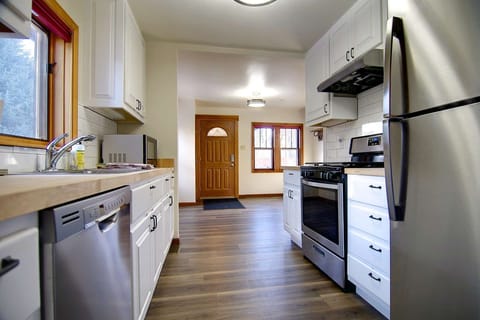 A beautiful updated kitchen with stainless steel appliances and butcher counters.