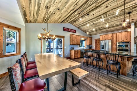 A rustic antler chandelier hangs above the custom dining table that seats 10