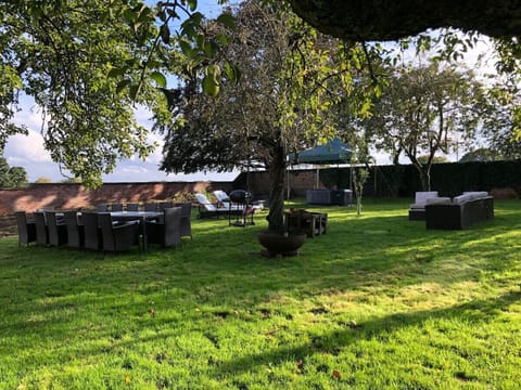 The walled garden private to you - with the free hot tub, outside seating and dining, charcoal BBQ and firepit
