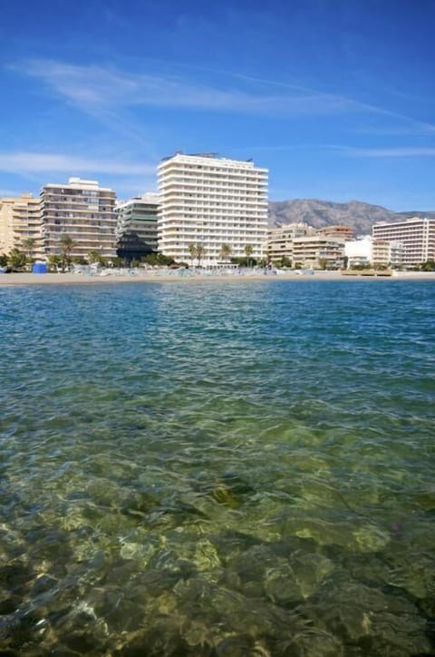 On the beach, white sand, sun loungers, beach umbrellas