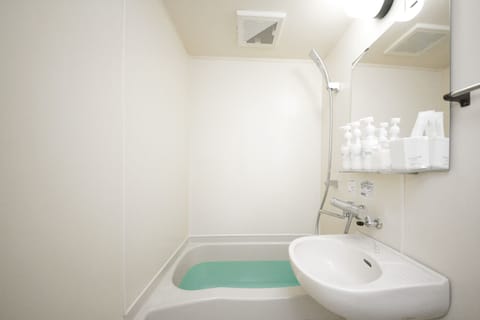 Separate tub and shower, free toiletries, hair dryer, slippers