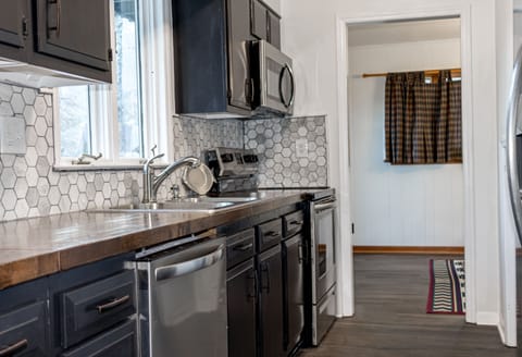 Clean kitchen with new appliances and fully stocked with cook ware