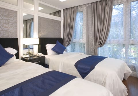 Deluxe Room, City View | Pillowtop beds, minibar, in-room safe, individually decorated