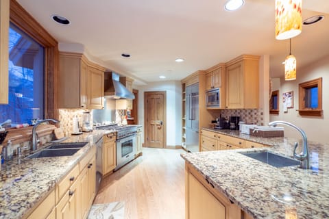 The kitchen of this Telluride ski rental, with two sinks and stainless steel appliances.