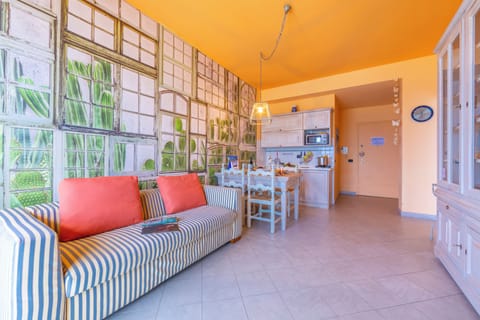 Family Apartment, 1 Bedroom, Sea Facing (Laigueglia Beach) | Living area | 22-inch flat-screen TV with cable channels, TV