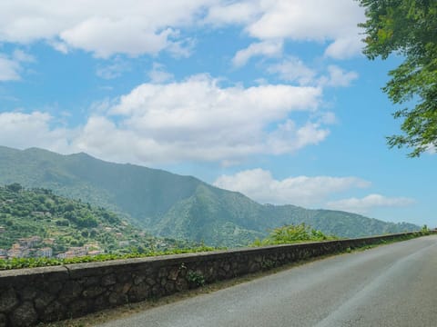 Cloud, Sky, Mountain, Plant Community, Ecoregion, Green, Plant, Natural Landscape, Road Surface, Asphalt
