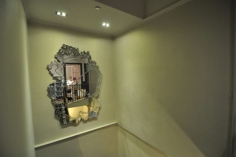 stairwell with large venetian mirror