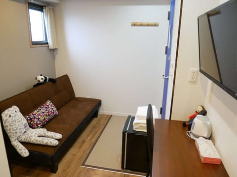 Family Double Room | Living room | 24-inch flat-screen TV with cable channels, TV