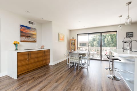 Open floor plan featuring the dining table set to accommodate four guests.