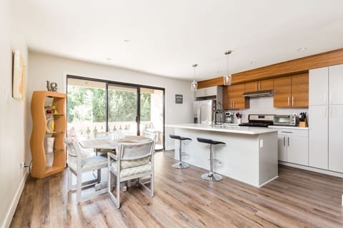 Modern Kitchen fully equipped with stainless steel appliances and stocked with basic cooking essentials.