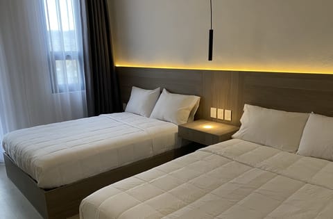 Comfort Quadruple Room | Down comforters, pillowtop beds, individually decorated