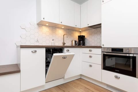 Kitchenette with oven and refrigerator. 