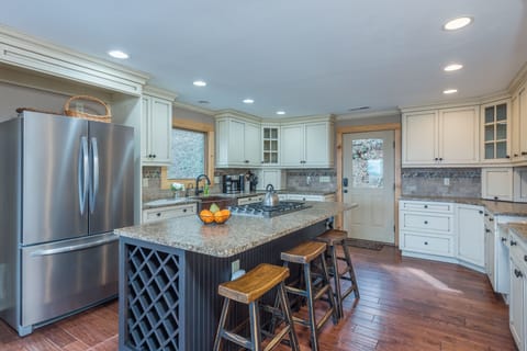 Large kitchen with double oven, pantry, oversized copper farm sink, five-burner propane gas stove, and 2 types of coffeemakers (Standard Drip & Keurig)