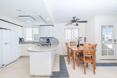 Dining table sits adjacent to the kitchen on one side and living room on the other. Headquarters for family meals, games and conversation.