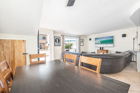 Open floor plan between living, kitchen and dining areas. Tile flooring throughout.