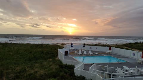 Seasonal outdoor pool, open 9:00 AM to 8:00 PM, pool umbrellas