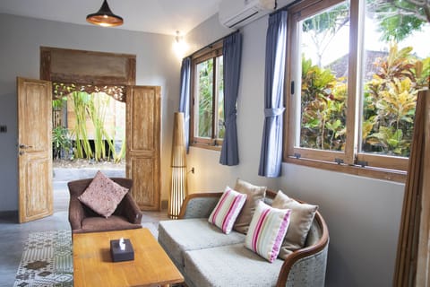 Two Bedroom Suite, Garden View | Living area | Flat-screen TV