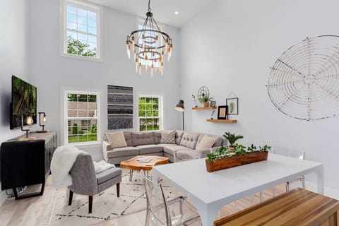 Welcome to our space, The Brownstone! With high vaulted ceilings & plenty of sleek seating areas, the living room is perfect for catching up, enjoying meals, and kicking back in front of our large 76-inch HDTV.