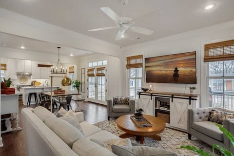 The living area has plush comfortable seating, a 63-inch HDTV with cable and Netflix, and plenty of warm lighting for you to pull down the custom bamboo blinds, cozy on up, and hop in a book. Post-picture additions: A sound system and subwoofer. 