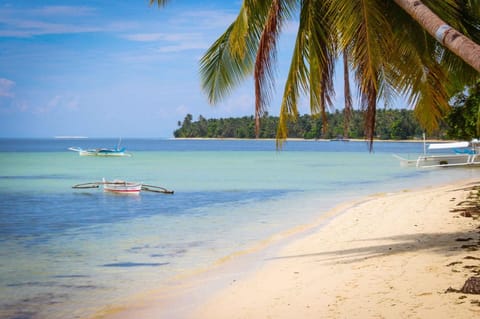 On the beach, white sand, sun loungers, beach towels