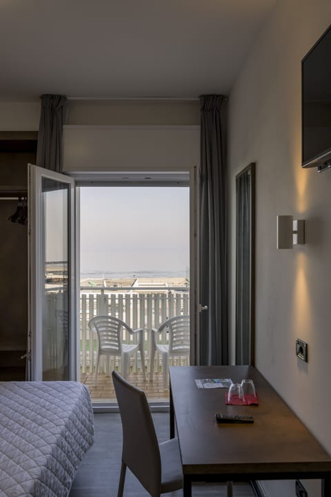 Triple Room, Sea View | Minibar, in-room safe, desk, free WiFi