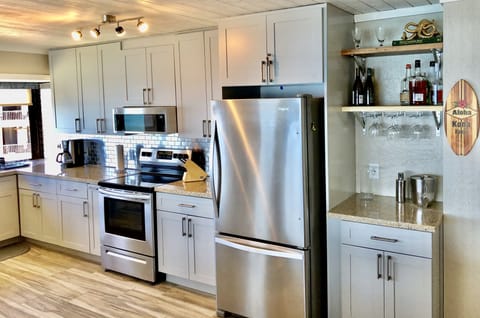 Brand new kitchen with stainless appliances.